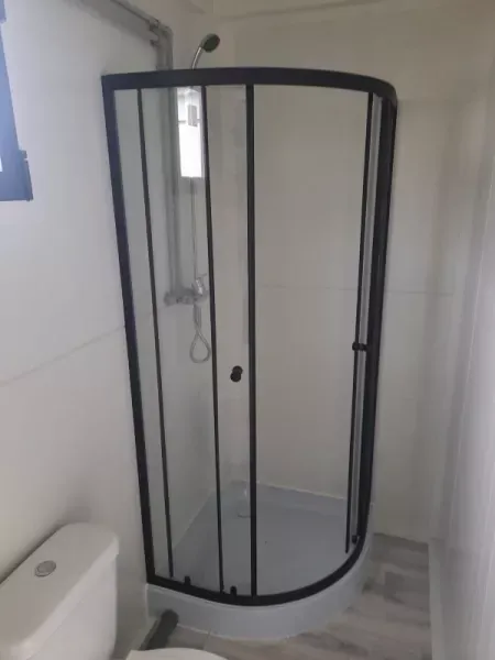 Shower cubicle inside the sanitary container