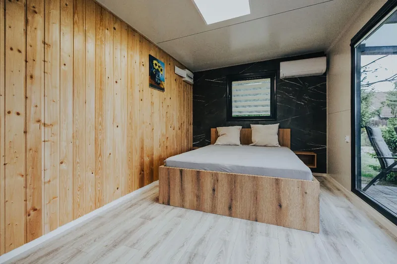 Sleeping area with timber cladding and floor-to-ceiling glazing